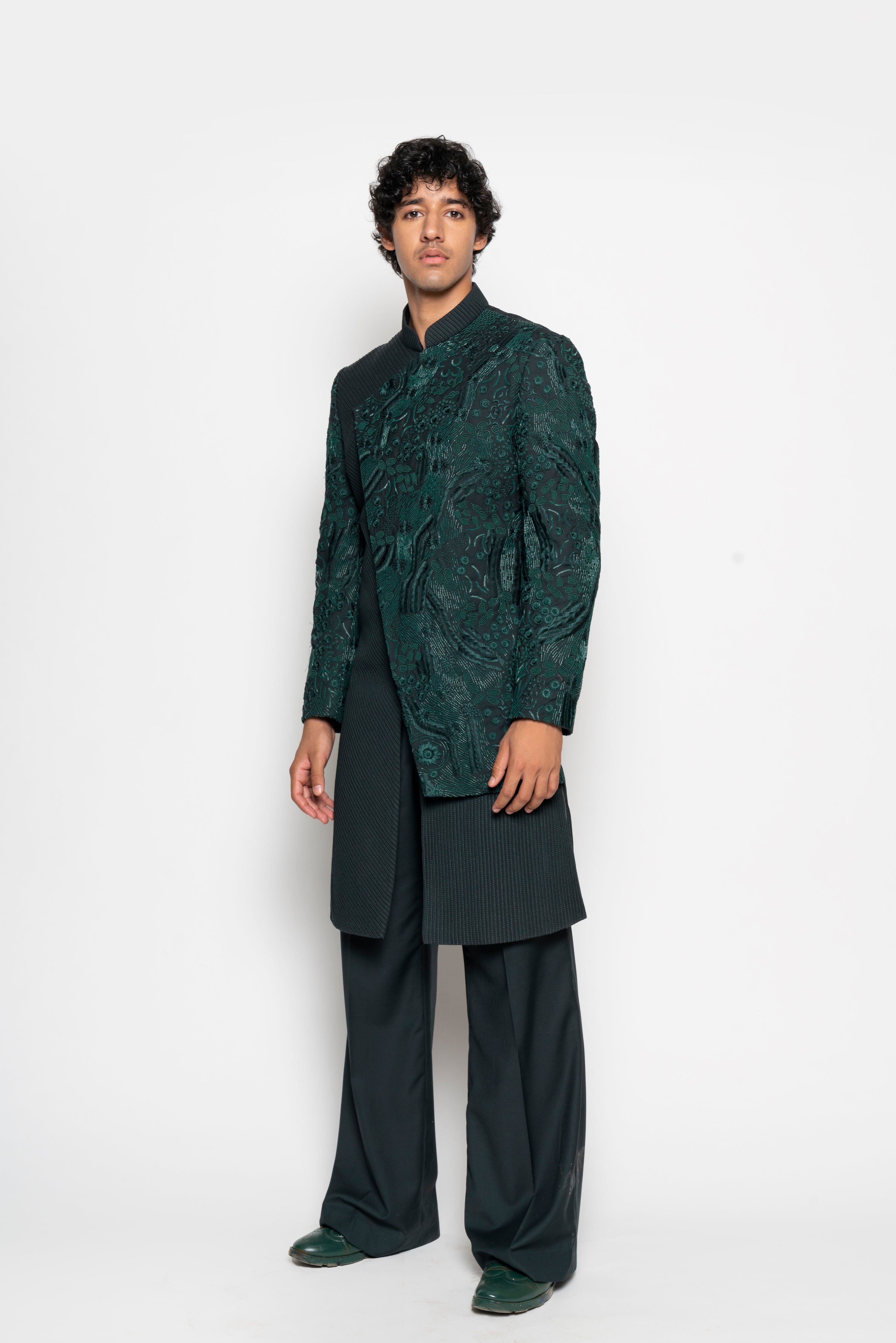 The richness of this dark emerald outfit is only enhanced by the minute embroidery across the diagonally cut front panel.