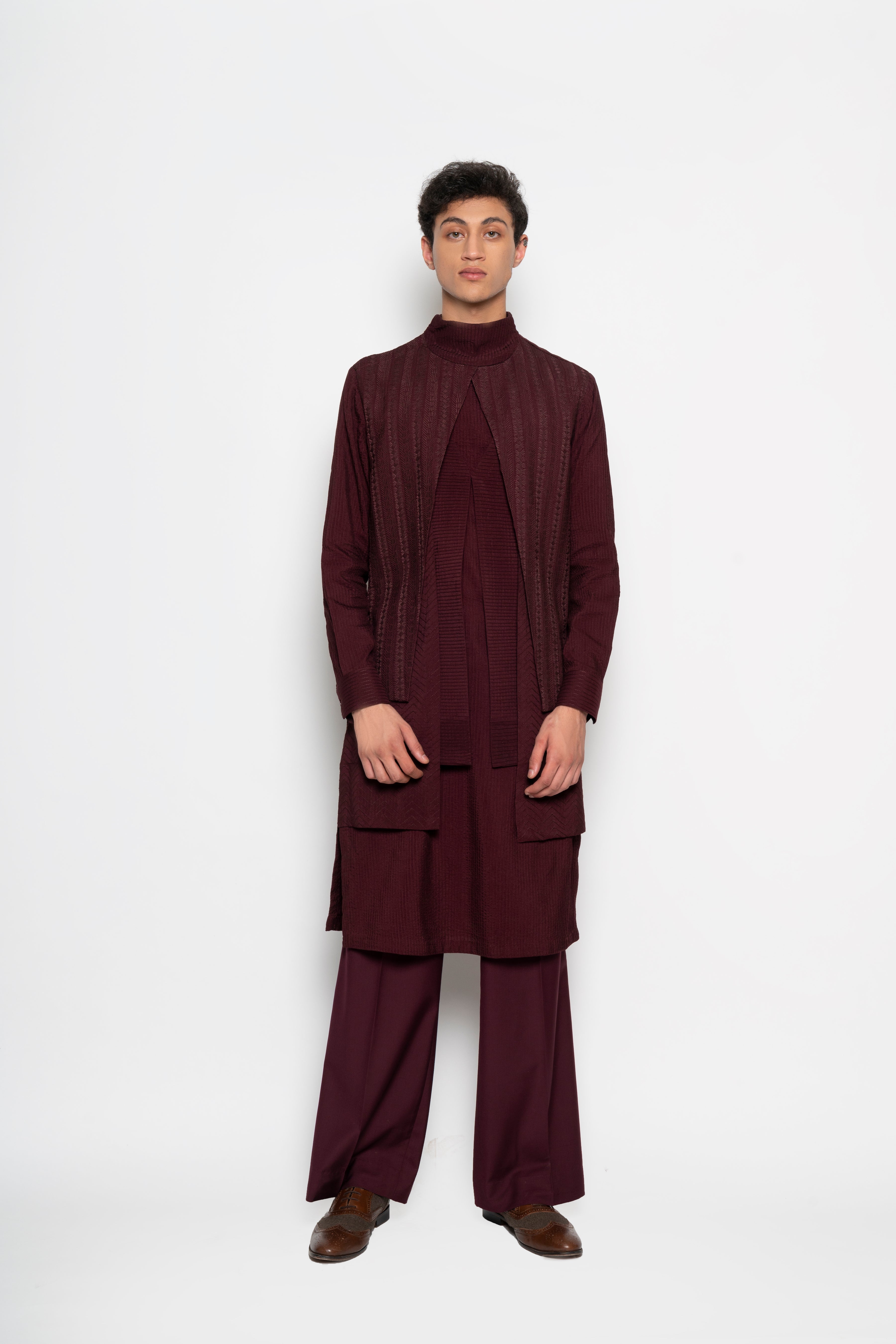 Layered Kurta in Wine with stitchwork and embroidery all over for a resplendent tonal texture. 
